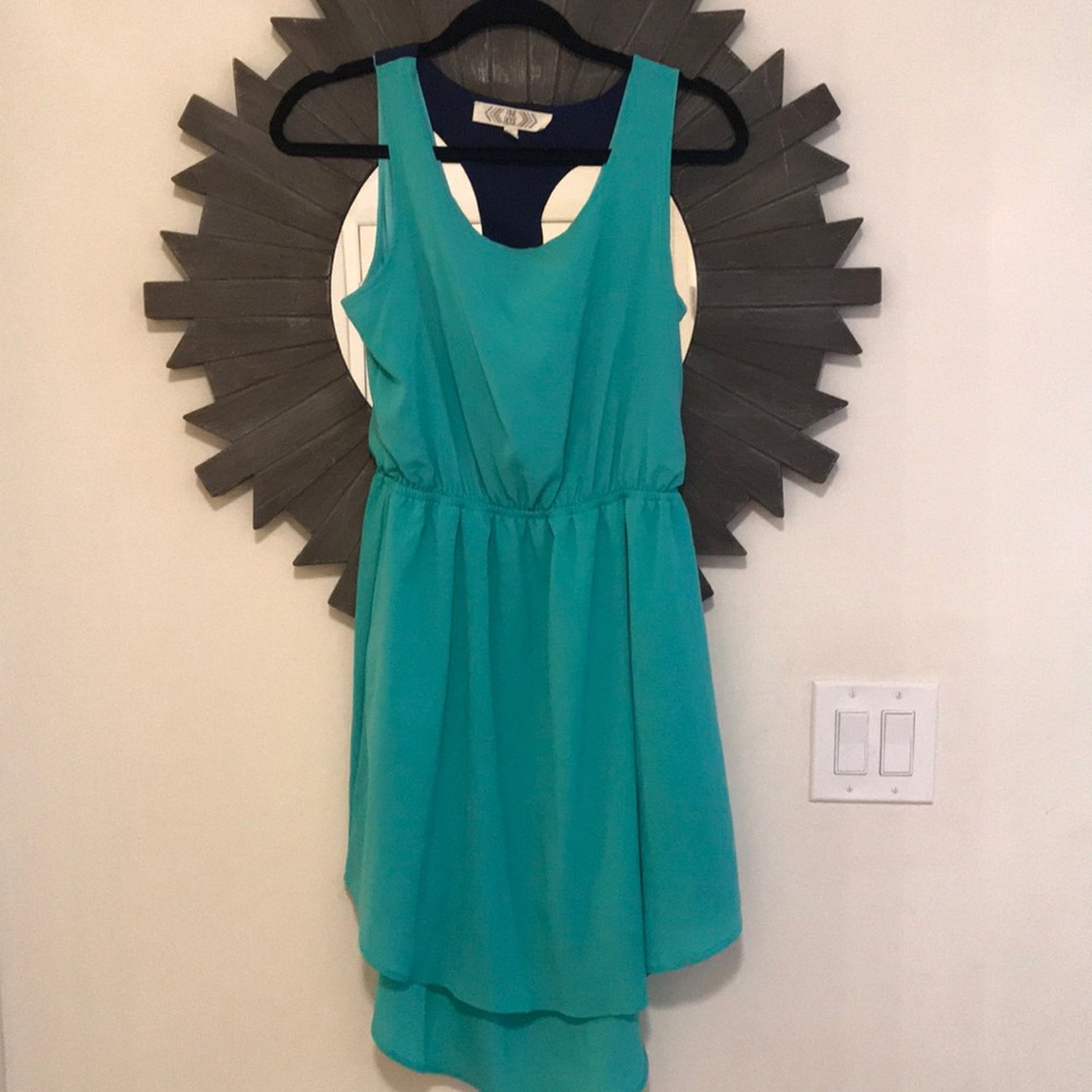 Hi-low teal dress with back cutout and navy accent